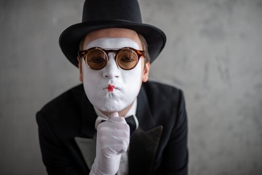 Close up portrait of a sad male mime wearing double glasses