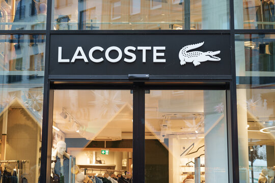 Dusseldorf, Germany - November 26 2025: Lacoste storefront with its iconic crocodile logo on a busy D&uuml;sseldorf street