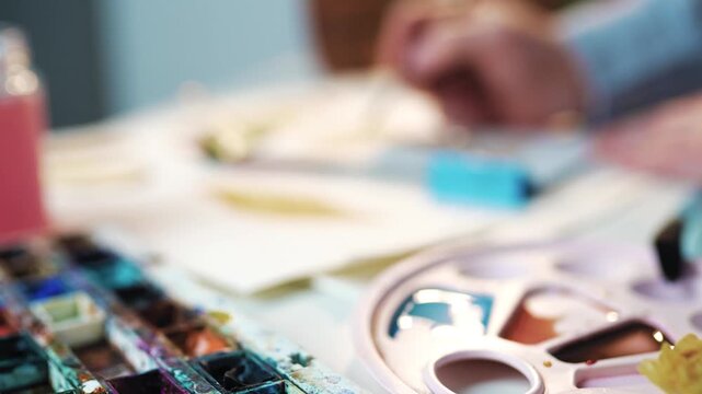 Artist Drawing with Watercolors at Creative Studio Desk