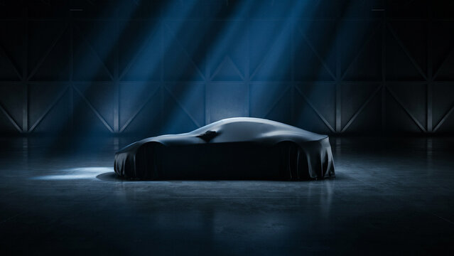 Luxury car hidden under a protective cover in a dark garage under spotlights with sportscar spotlight protection automotive showroom unveiling silhouette performance transportation marketing