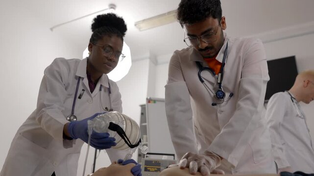 Medical students practicing cardiopulmonary resuscitation on a dummy