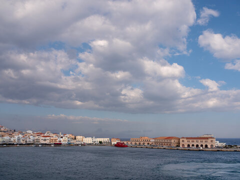 Sunset view from the sea to the capital of the island of Syros, Ermoupolis, Greece