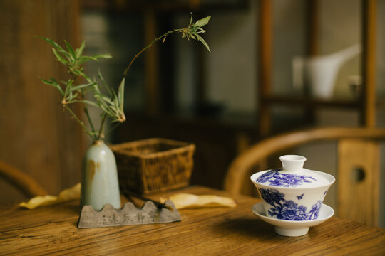 Chinese jasmin tea on a wooden table in a yard.