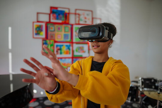 High school student using virtual reality for immersive learning in classroom.