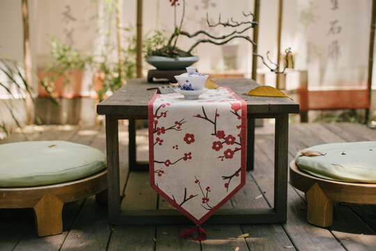 Chinese jasmin tea on a wooden table in a yard.