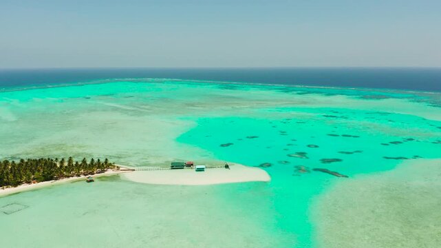 Tropical island with beautiful beach, palm trees and turquoise water view from above. Onok Island, Balabac, Philippines. Summer and travel vacation concept
