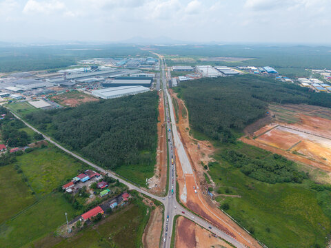 Aerial view of the Malaysia Federal Route 4 FT4 road upgrading project, showing construction progress and surrounding industrial and rural areas in Karangan, Kedah, Malaysia.