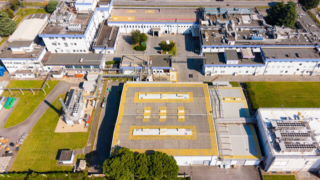Aerial view of Centro di distribuzione Esselunga di Liscate, a large industrial logistics facility with flat rooftops, HVAC units, and surrounding green areas in Liscate, Lombardia, Italy.