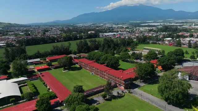 Aerial view of a college campus with a large grassy field in Guzman City, Mexico