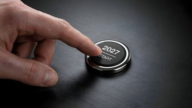 2027 start button pressed by hand, future planning and vision concept, new year 2027 ignition button on dark background