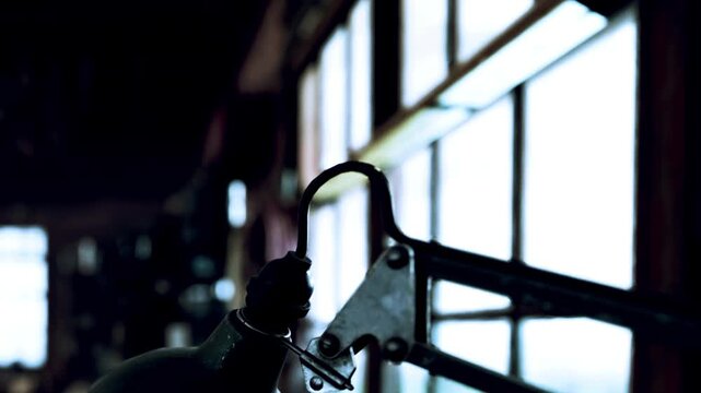 In a workshop filled with natural light, a craftsman works diligently on a project, surrounded by tools and materials. The atmosphere buzzes with creativity and dedication.