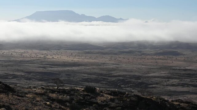 In the early morning, clouds drift over beautiful hills,  African landscape. Timelapse