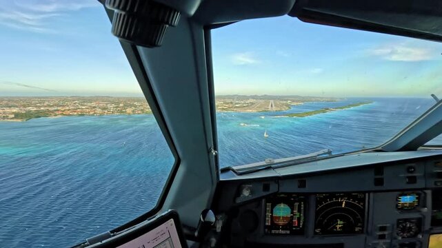 Pilot cockpit view landing at Aruba Airport over Caribbean coast