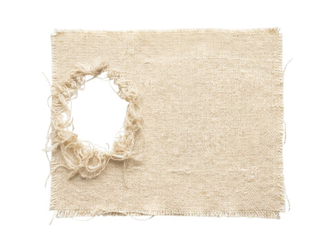 Rectangular piece of natural beige woven textile featuring a coarse canvas texture with a circular torn hole and heavily frayed edges on the left side transparent background