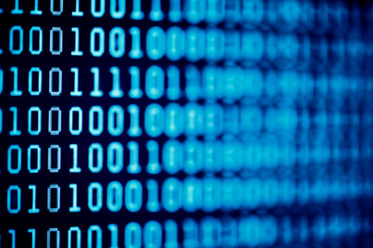 Binary code background on computer screen