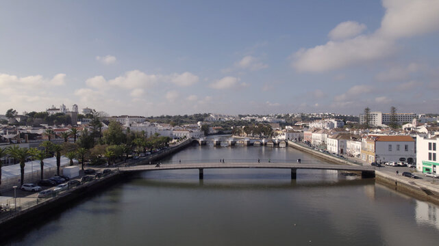 Aerial view of the historic Roman Bridge spanning the Gilao River in the charming town of Tavira, Faro District, Portugal.
