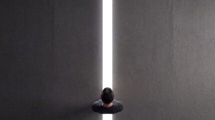 Fototapeta premium Top down view of a man standing in a narrow gap between two massive concrete walls, looking towards a bright white light that symbolizes hope, opportunity, freedom, and a new beginning.