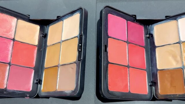 Eyeshadow and Blush Palettes on Display in Cosmetics Store &ndash; Colorful Makeup Products on Shelf