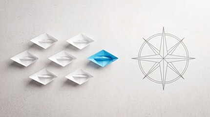 Fototapeta premium Top down overhead view of a blue paper boat leading a fleet of white boats towards a compass symbol, representing leadership, business strategy, guidance, and unique direction on a grey background.