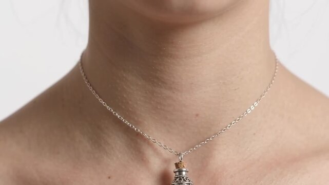 Close Up of Woman Neck Wearing Vintage Silver Filigree Potion Bottle Pendant Necklace