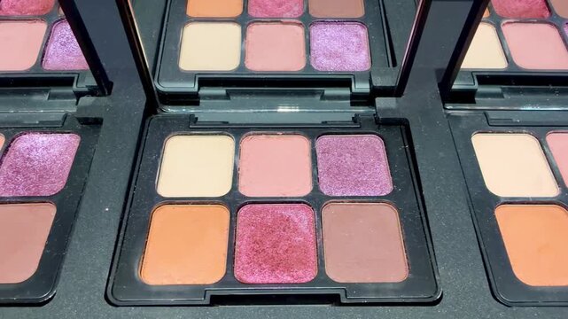 Eyeshadow and Blush Palettes on Display in Cosmetics Store &ndash; Colorful Makeup Products on Shelf