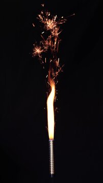 Firework bursts gold sparks against dark background