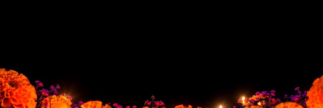 Marigolds and glowing candles on black background, Day of the Dead website banner with copy space