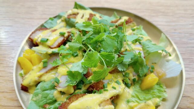 Plate of Asian Chicken Salad Topped with Fresh Cilantro on Table &ndash; Healthy Vietnamese or Thai Style Salad