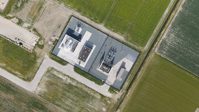 Aerial view of the Westermeerdijk electrical substation surrounded by green agricultural fields and farmland in Espel, Flevoland, Netherlands.