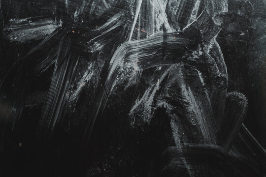 dark glass texture and background with dust stains and paint marks
