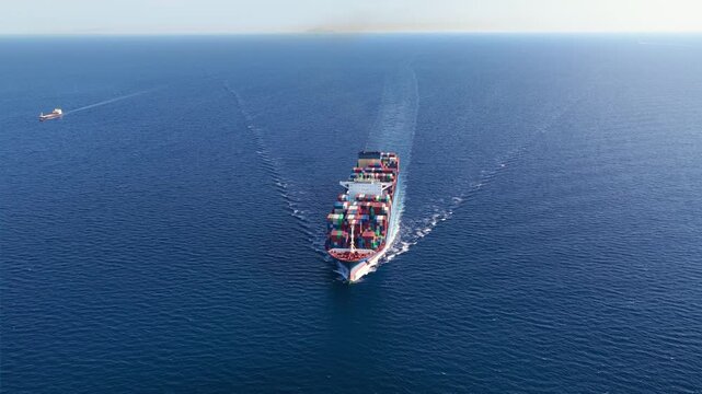 Panoramic aerial view of a large container cargo ship cruising over the ocean as a concept for logistics and shipping