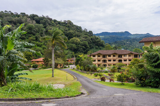 Residential community in Boquete, Panama, on a cloudy day with green forested mountain backdrop.