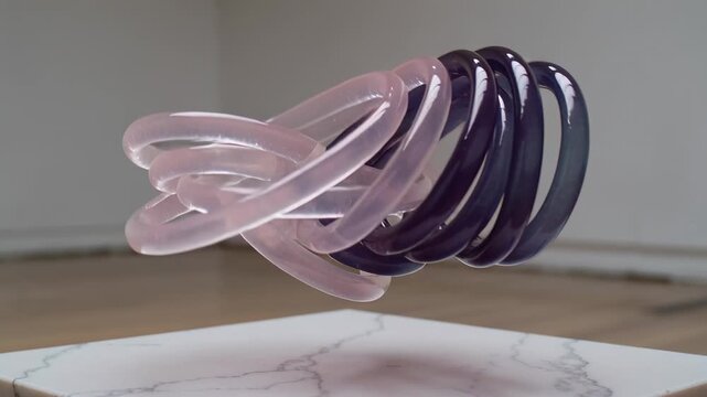 Starting clip causing floating linked rings rotating, shifting teal-to-purple above marble plinth
