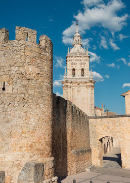 Stone Against Splendour: Medieval Walls Framing an Ornate Spanish Cathedral Tower