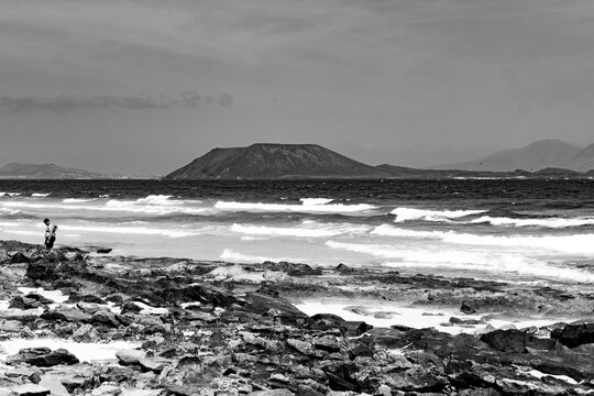 Black and white seascape with a distant island