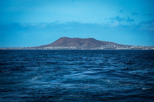 Distant island landscape across a blue sea
