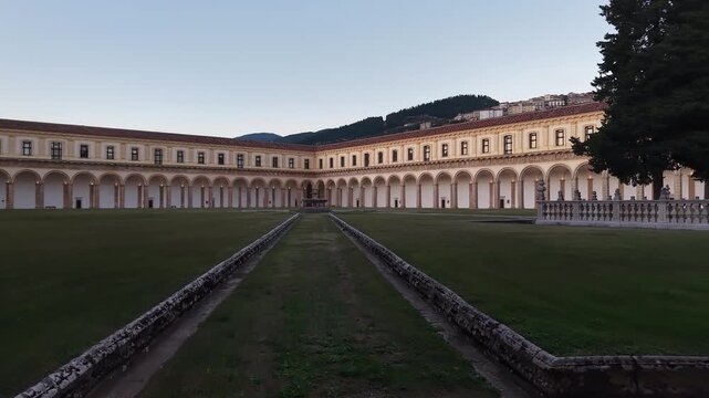 Wide view of the Great Cloister of the Certosa di Padula, one of the largest cloisters in the world, at blue hour, Campania, Italy