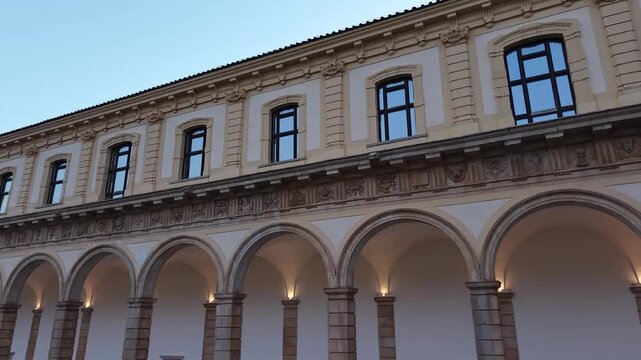 Low angle view of the arcades and windows of the Great Cloister at the Charterhouse of Padula, Salerno, Campania, southern Italy