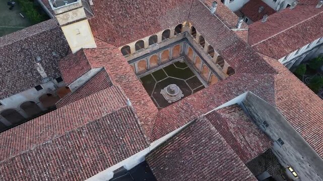 Aerial view of the cloister and bell tower of the Carthusian monastery of Padula with its terracotta roofs, Salerno, southern Italy