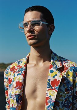 fashionable young man in floral shirt and glasses