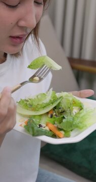 Young Woman Hesitating to Eat Healthy Vegetable Salad