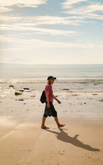 Active senior woman walking profile on Cadiz beach at sunset © Paolo Corazza