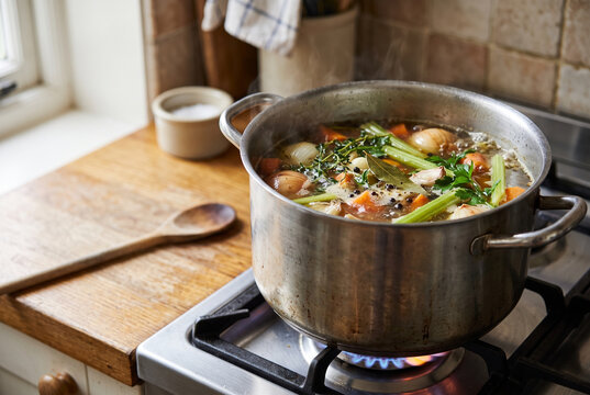 Homemade vegetable stock simmering in a pot