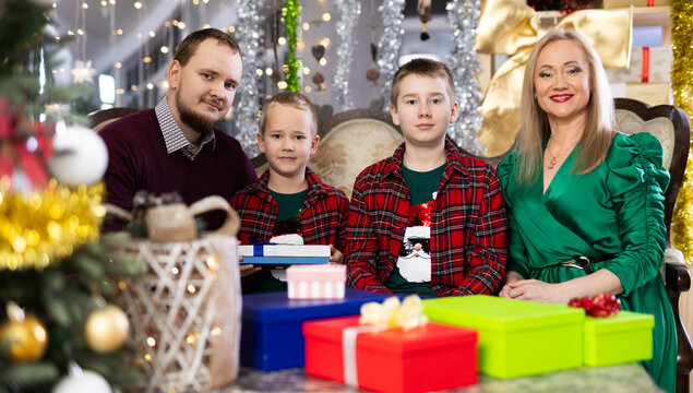 Family with mom and dad celebrates Christmas at home
