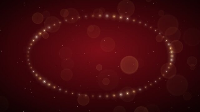 Elegant swirling golden light particles forming an oval shape on a dark red bokeh background