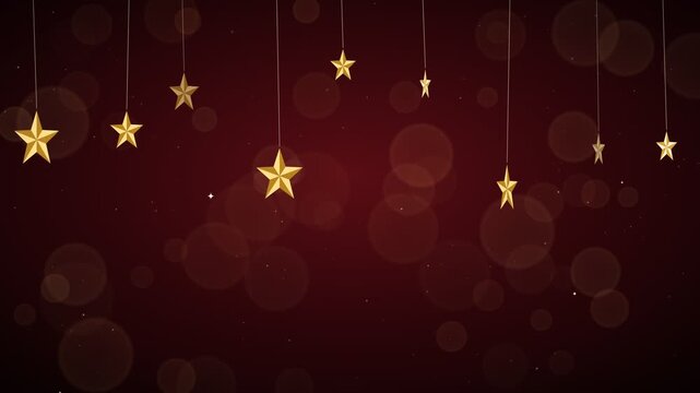 Golden stars hanging and sparkling on a dark red background with bokeh lights and particles