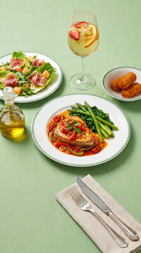 Basque-style tuna, salad with cured ham, croquettes, and a glass of white wine sangria