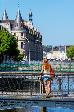 woman tourist standing on footbridge looking at prefecture building quimper france travel concept