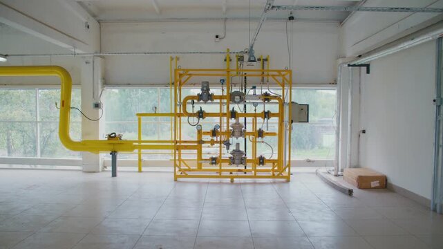 Yellow gas piping manifold with valve rack, pressure gauges, and regulators