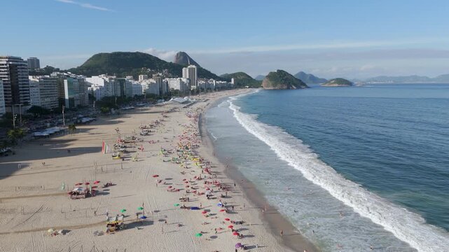 Aerial view of Copacabana Beach with Sugarloaf Mountain in the background on a sunny day, Rio de Janeiro, Brazil.
